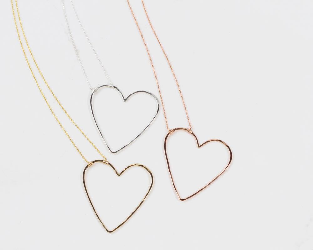 Our design is delightfully asymmetrical, just like being swept off your feet. The bold 1.75 X 1.75 inch heart pendant is wire wrapped to our barely there 1.1mm chain. You have the choice of 3 fine metal styles for your heart necklace as shown here.
