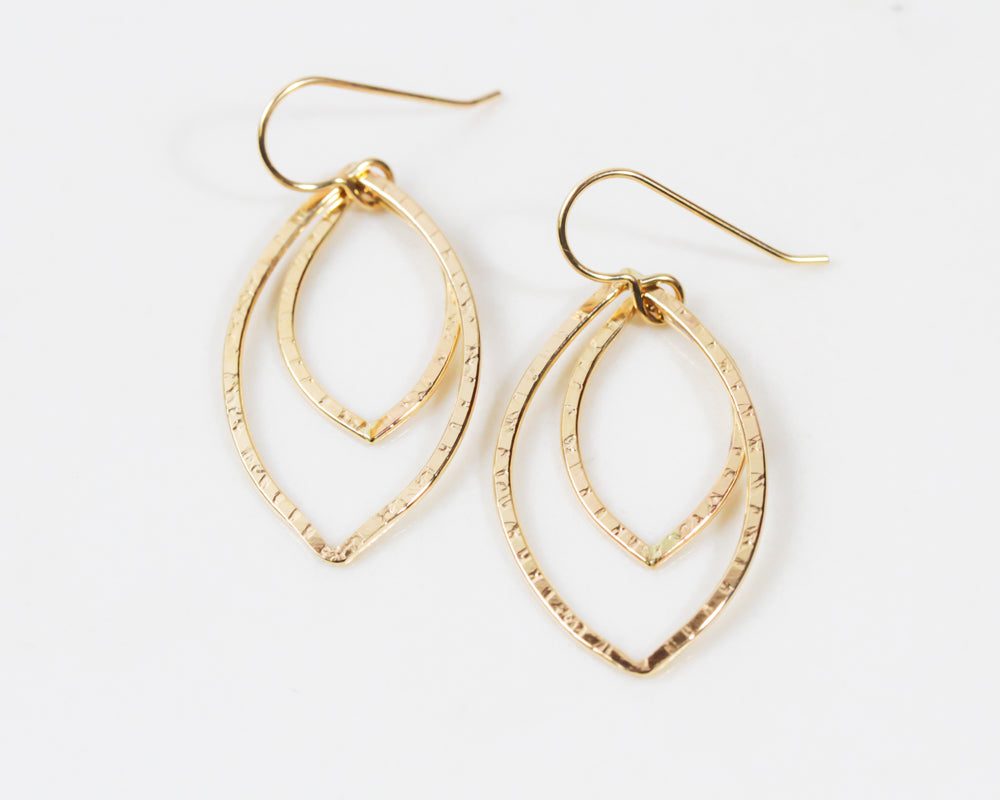 Close up image shows the all 14 karat gold filled format. The subtle texture denotes the veins of the leaf. Handmade and handcrafted in the USA, each pair is made to order in our charming studio in Northern California. Great gift, everyday wearable.